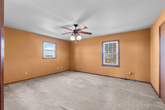 spare room featuring light carpet and ceiling fan