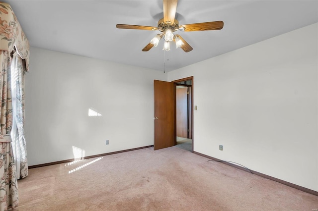 spare room with light carpet and ceiling fan