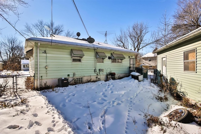 view of snow covered back of property