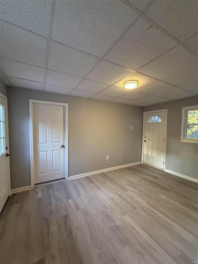 foyer entrance featuring a drop ceiling and hardwood / wood-style flooring