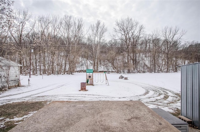 yard covered in snow with a playground