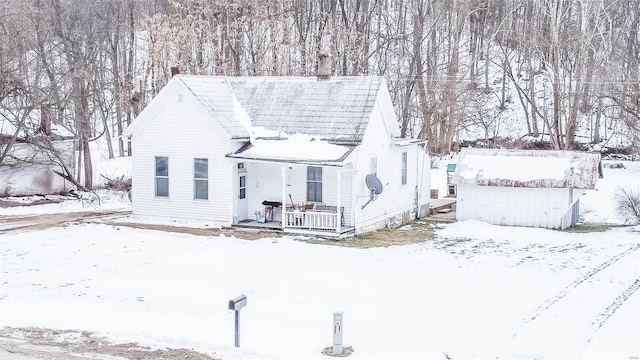 view of snow covered back of property