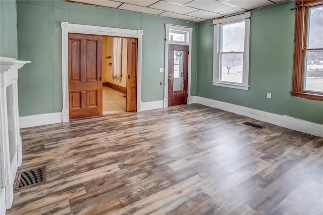 entrance foyer with a paneled ceiling and wood-type flooring