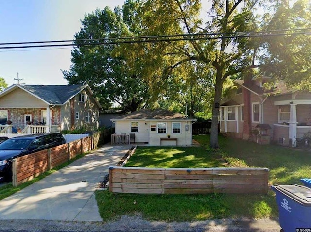 bungalow-style home with a front lawn