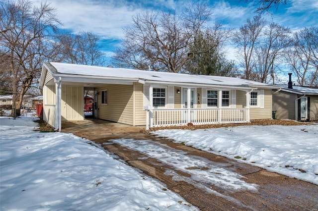 single story home with a porch and a carport