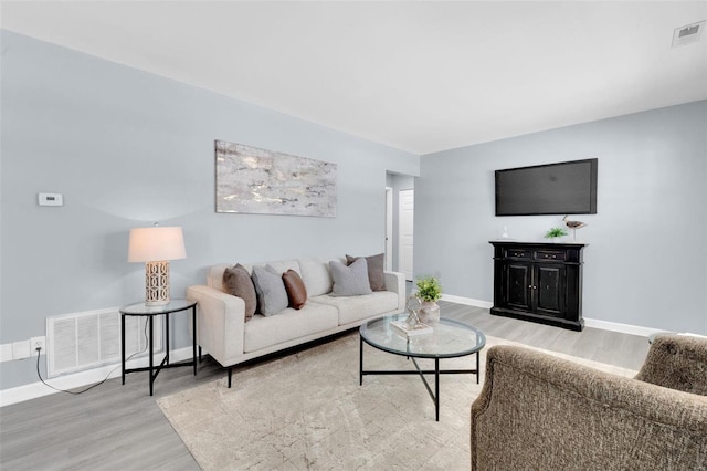 living room with light hardwood / wood-style flooring