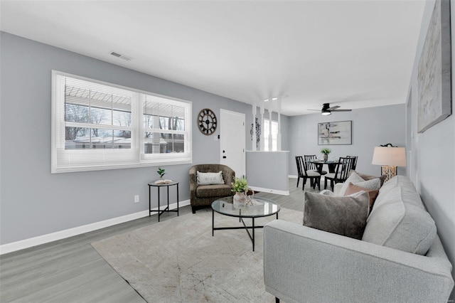 living room with ceiling fan and hardwood / wood-style flooring