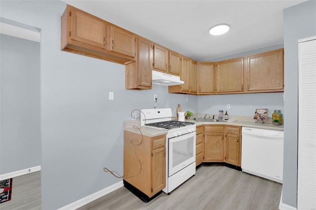 kitchen with light hardwood / wood-style floors, sink, white appliances, and light brown cabinetry