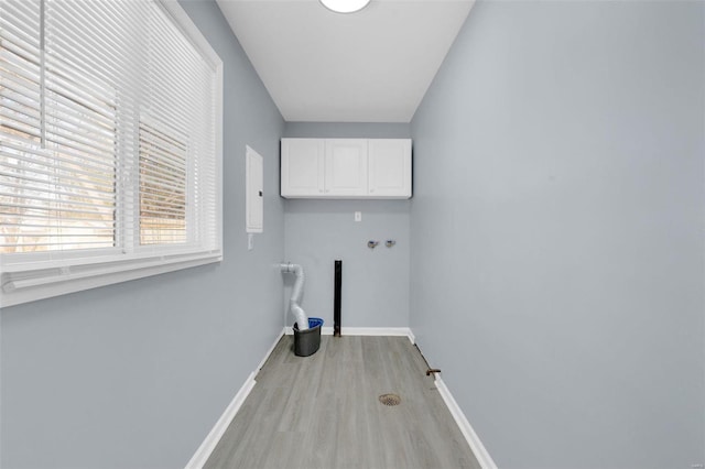 laundry room with cabinets, light hardwood / wood-style flooring, and hookup for a washing machine