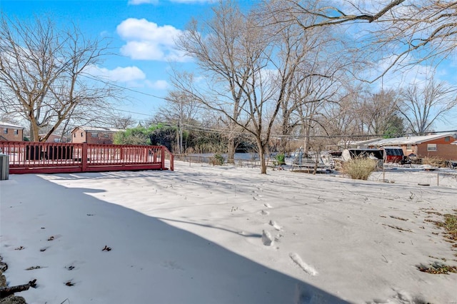 yard layered in snow with a wooden deck