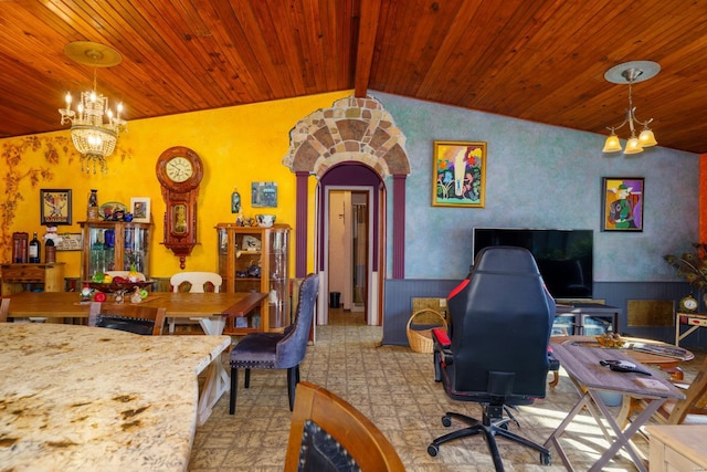 dining area featuring vaulted ceiling with beams and a notable chandelier