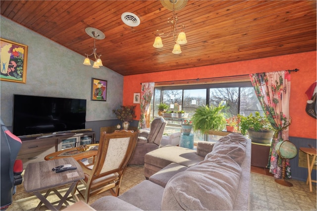 living room with a chandelier and vaulted ceiling