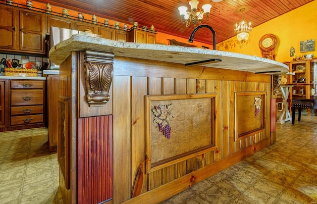 kitchen featuring wood ceiling, pendant lighting, a notable chandelier, and wooden walls