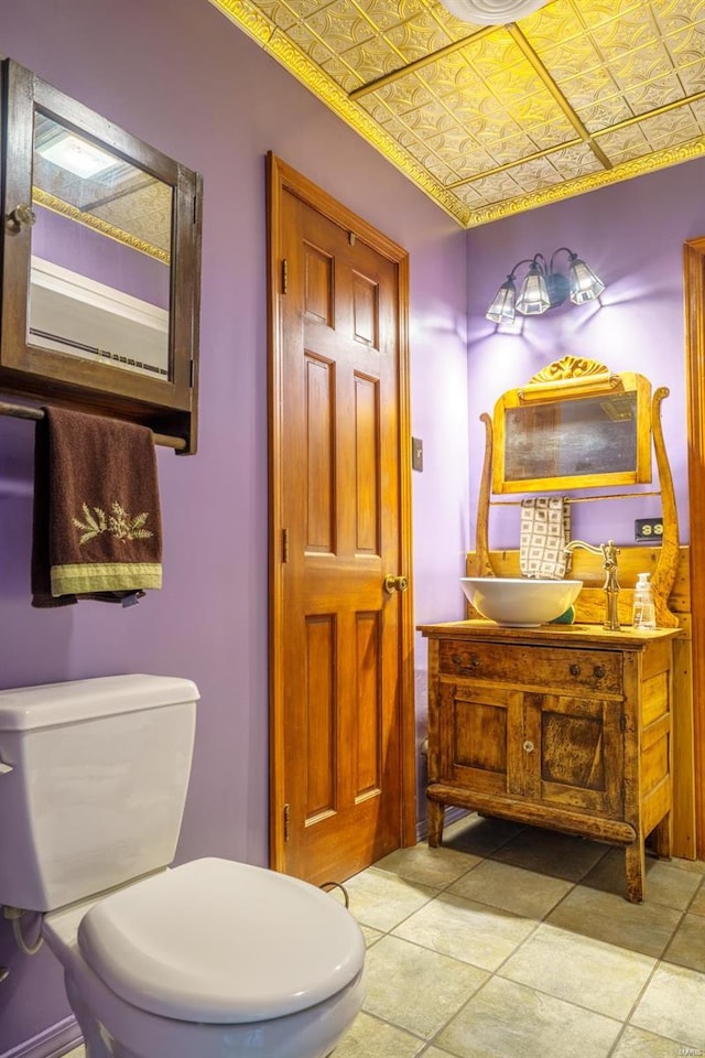 bathroom featuring tile patterned floors, toilet, and vanity