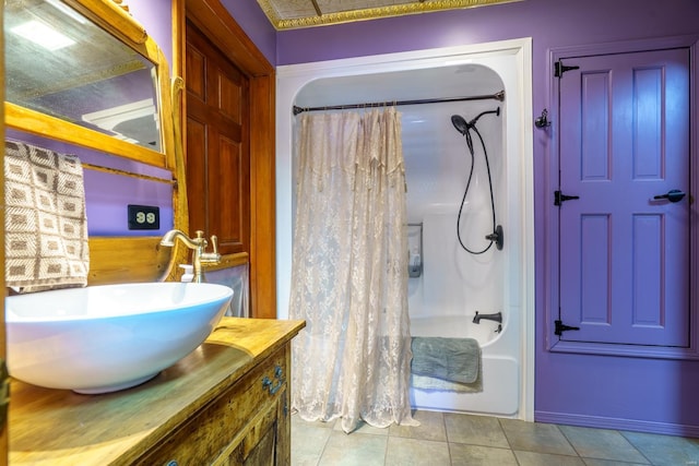 bathroom featuring tile patterned floors, vanity, and shower / tub combo with curtain