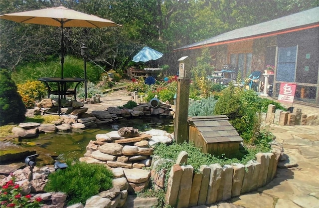 view of yard featuring a small pond