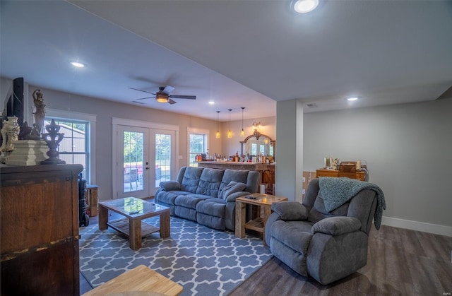 living room featuring ceiling fan, french doors, and dark hardwood / wood-style flooring