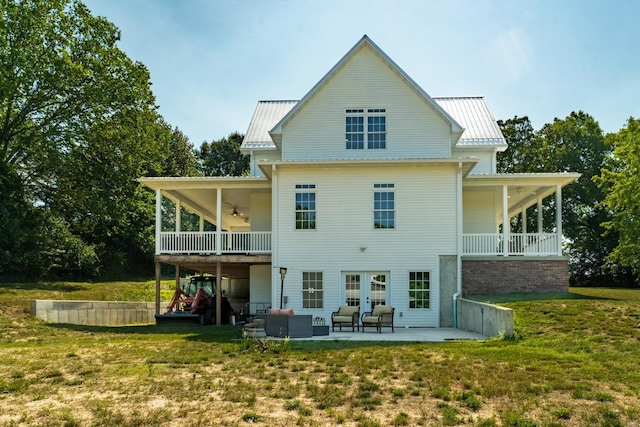 back of house with an outdoor living space, a patio area, a lawn, and ceiling fan