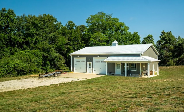 view of front facade with a garage, a front lawn, and covered porch