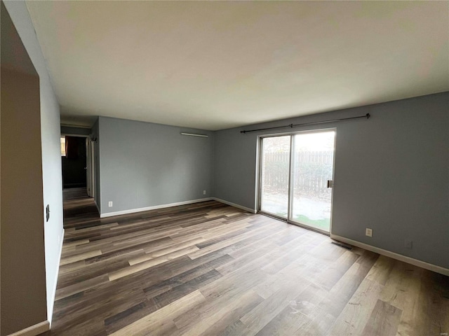 spare room featuring hardwood / wood-style flooring