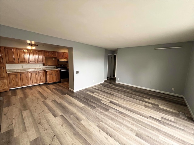 unfurnished living room with ceiling fan and hardwood / wood-style floors