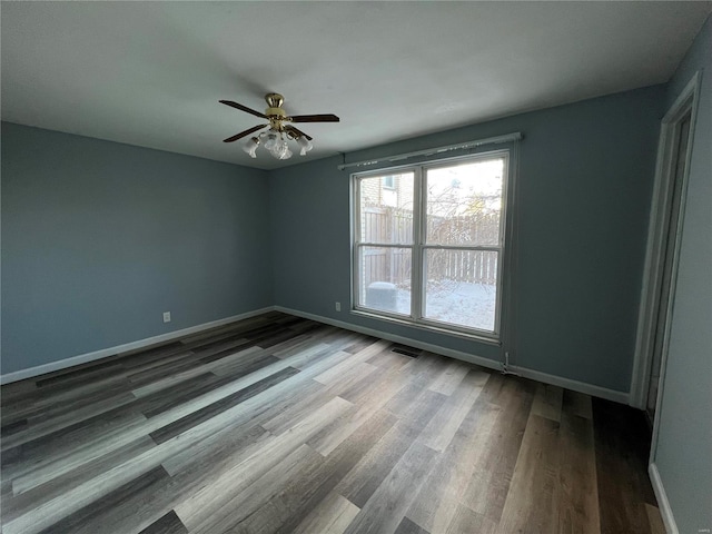 spare room with ceiling fan and hardwood / wood-style floors