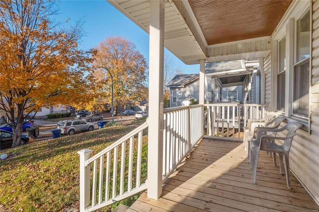 wooden terrace featuring covered porch