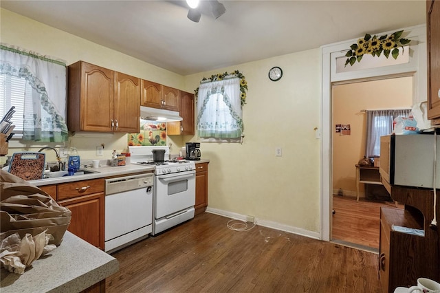 kitchen with ceiling fan, sink, dark hardwood / wood-style floors, and white appliances