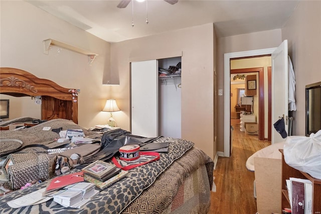 bedroom with a closet, light hardwood / wood-style floors, and ceiling fan