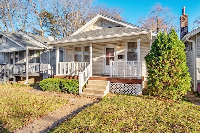 bungalow featuring a front lawn and a porch