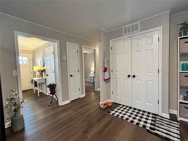 foyer featuring dark hardwood / wood-style floors and ornamental molding