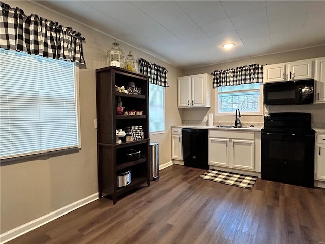 kitchen featuring white cabinetry, sink, dark hardwood / wood-style floors, and black appliances