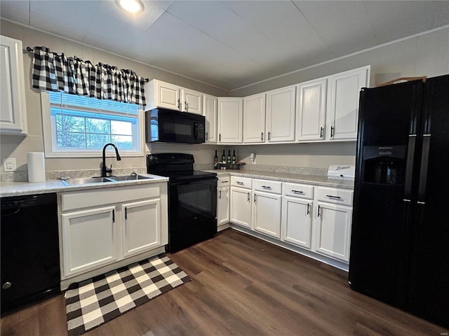 kitchen featuring black appliances, dark hardwood / wood-style flooring, sink, and white cabinetry