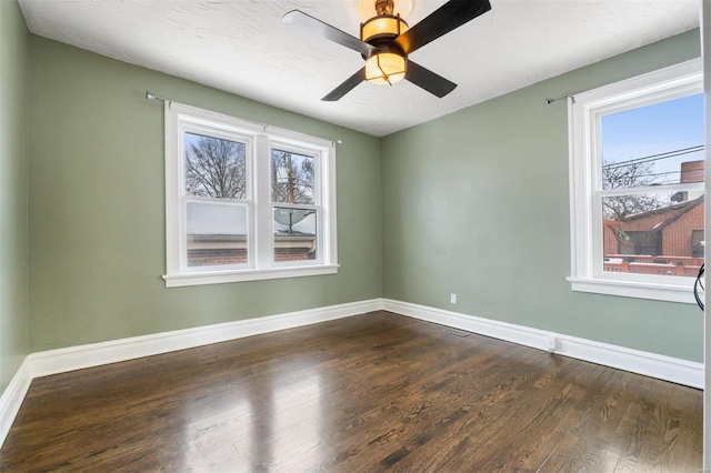 unfurnished room with ceiling fan and dark hardwood / wood-style floors