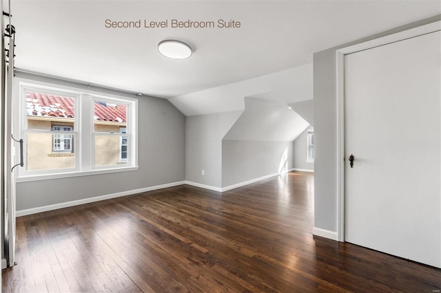 bonus room featuring dark hardwood / wood-style flooring and lofted ceiling