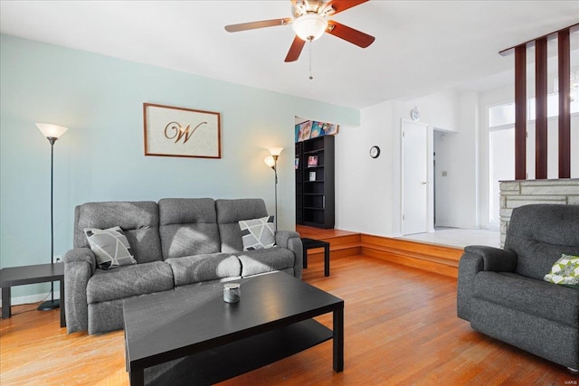 living room featuring ceiling fan and hardwood / wood-style floors