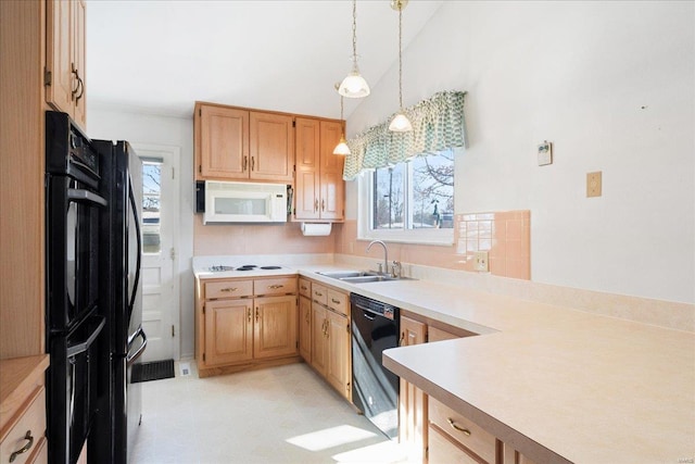 kitchen with black appliances, plenty of natural light, sink, and pendant lighting