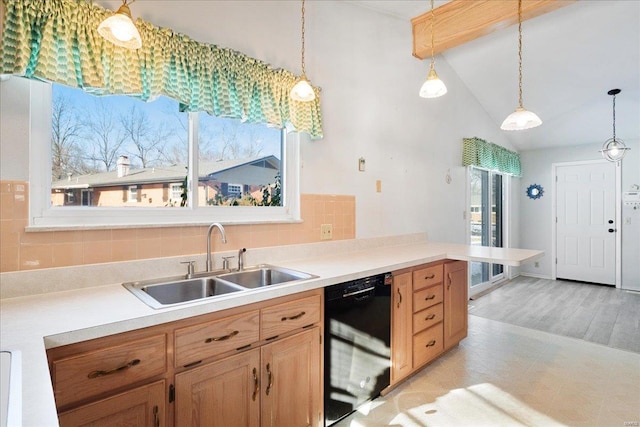 kitchen featuring backsplash, sink, hanging light fixtures, and black dishwasher