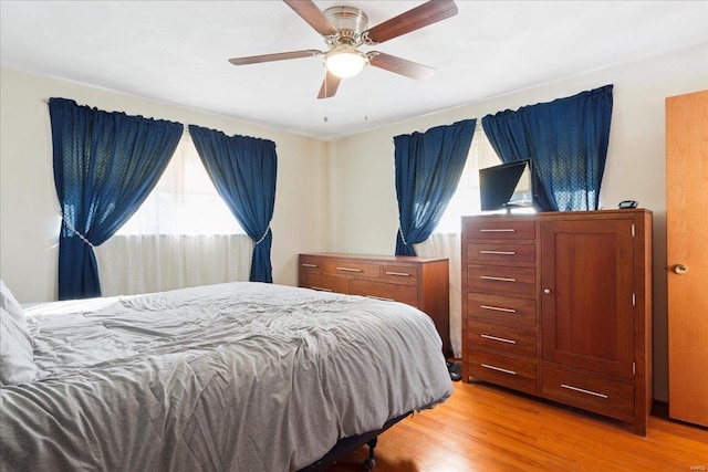 bedroom featuring ceiling fan and light hardwood / wood-style flooring