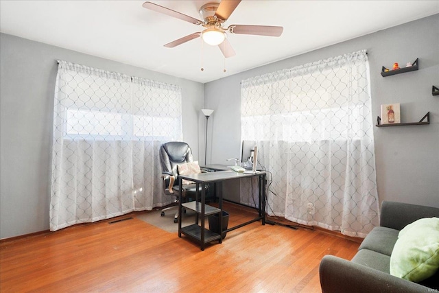 office space featuring ceiling fan and hardwood / wood-style flooring