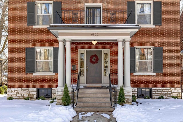 view of snow covered property entrance