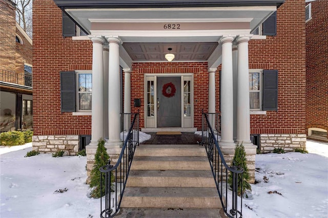 view of snow covered property entrance