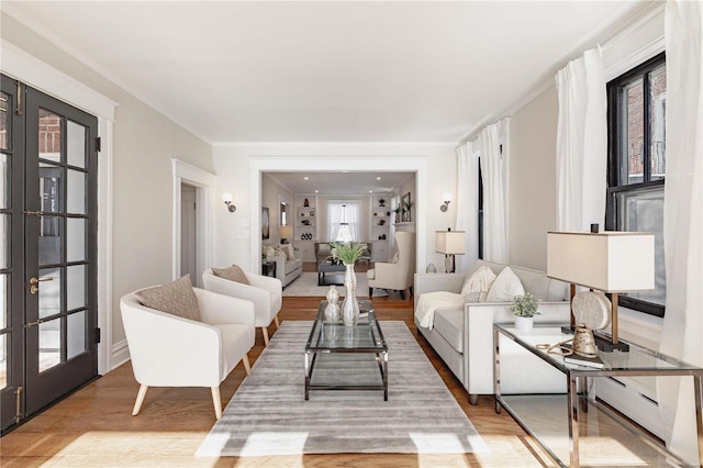 living room with light wood-type flooring, plenty of natural light, and french doors