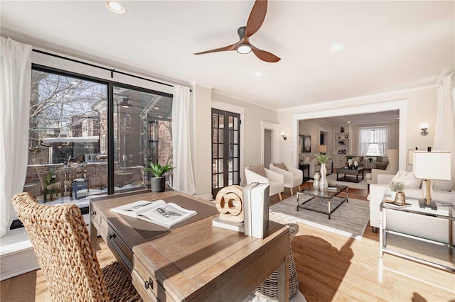 dining space with ceiling fan and light wood-type flooring