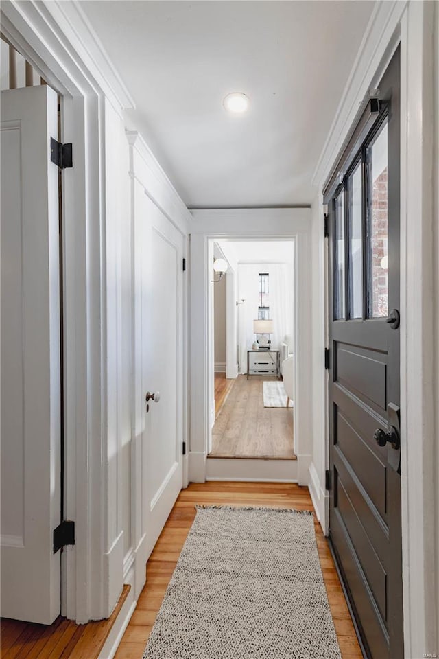 hallway with light hardwood / wood-style floors