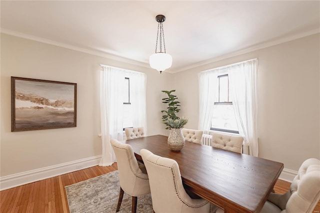 dining room featuring crown molding and hardwood / wood-style flooring