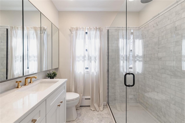 bathroom with toilet, vanity, baseboard heating, and an enclosed shower