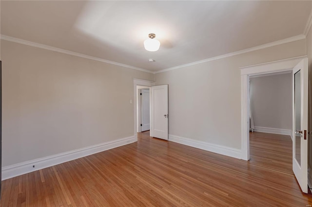 spare room featuring ornamental molding and hardwood / wood-style floors