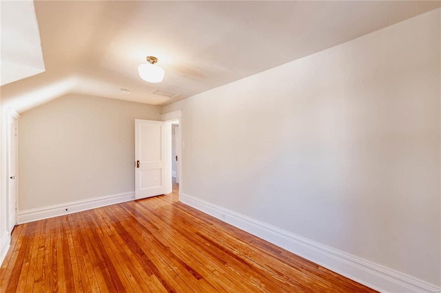 additional living space featuring lofted ceiling and wood-type flooring