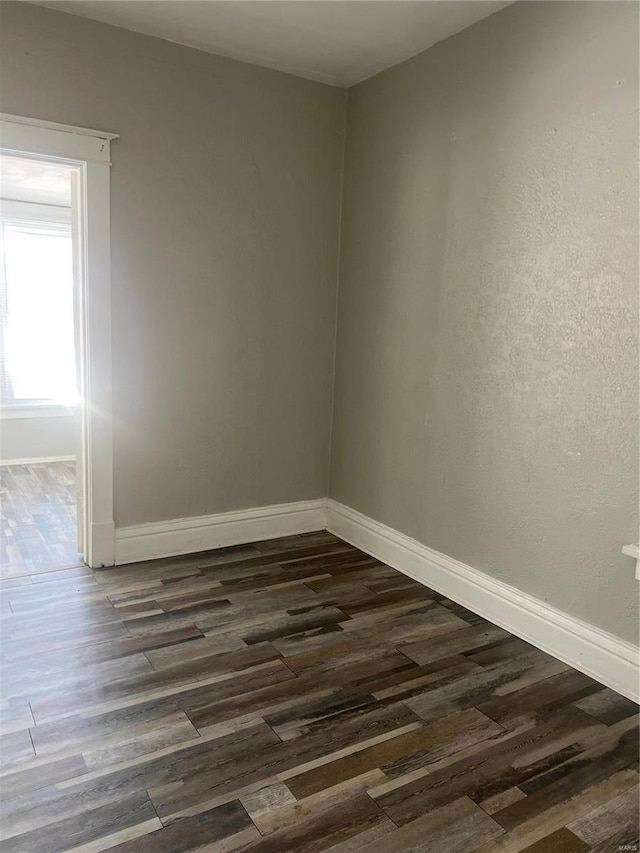 empty room featuring dark wood-type flooring